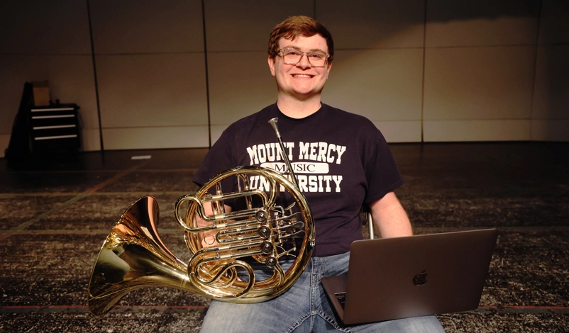 Eric Heitland holding french horn