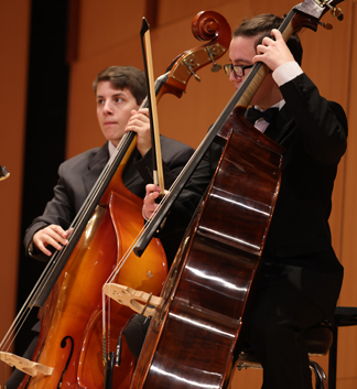 Strings ensemble members playing the cello