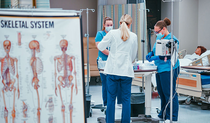 A student and professor using the state-of-the-art nursing sim lab