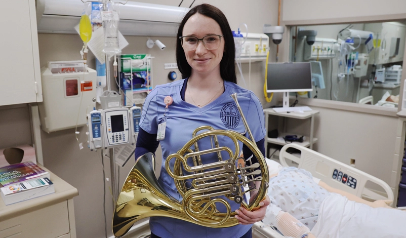 Mariah Peterson holding horn in the hospital room